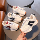 A boy in breathable white sneakers for children